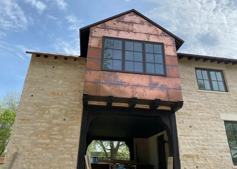 Copper metal panel facade on a stone building for Roof Repair in St. George
