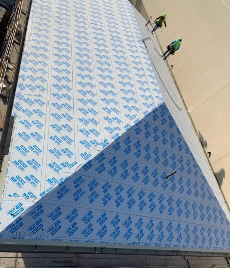 Professional roofers installing underlayment on a metal roof in St. George